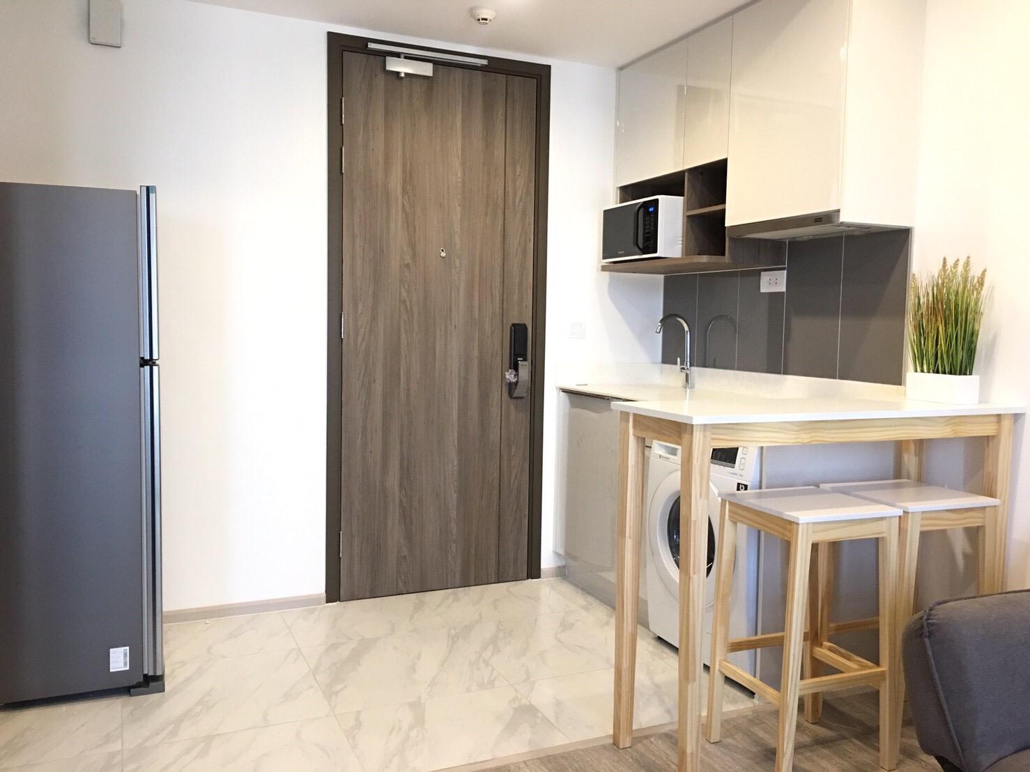 Bangkok condominium kitchen with fitted cupboards and appliances