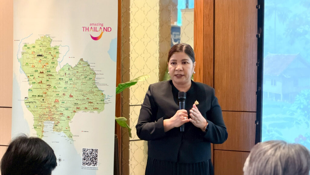TAT speaker presenting community tourism plans to travel partners in Bangkok